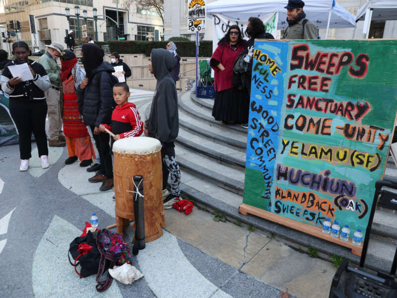 Homeless advocates attend a sweeps-free sanctuary protest outside of City Hall in Oakland, California, on December 17, 2024.