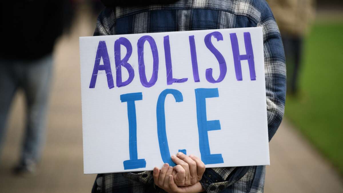 A demonstrator holds a sign that says “Abolish ICE” during a protest in Houston, Texas, on January 10, 2026.