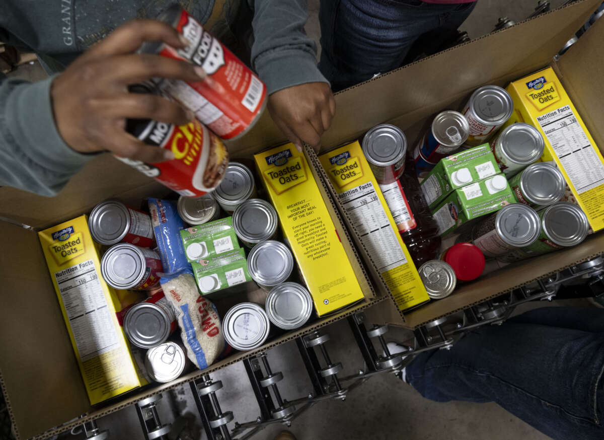 Volunteers pack boxes of shelf-stable food during the Martin Luther King Jr. Day of Service at the OC Food Bank in Garden Grove, California, on January 19, 2026.