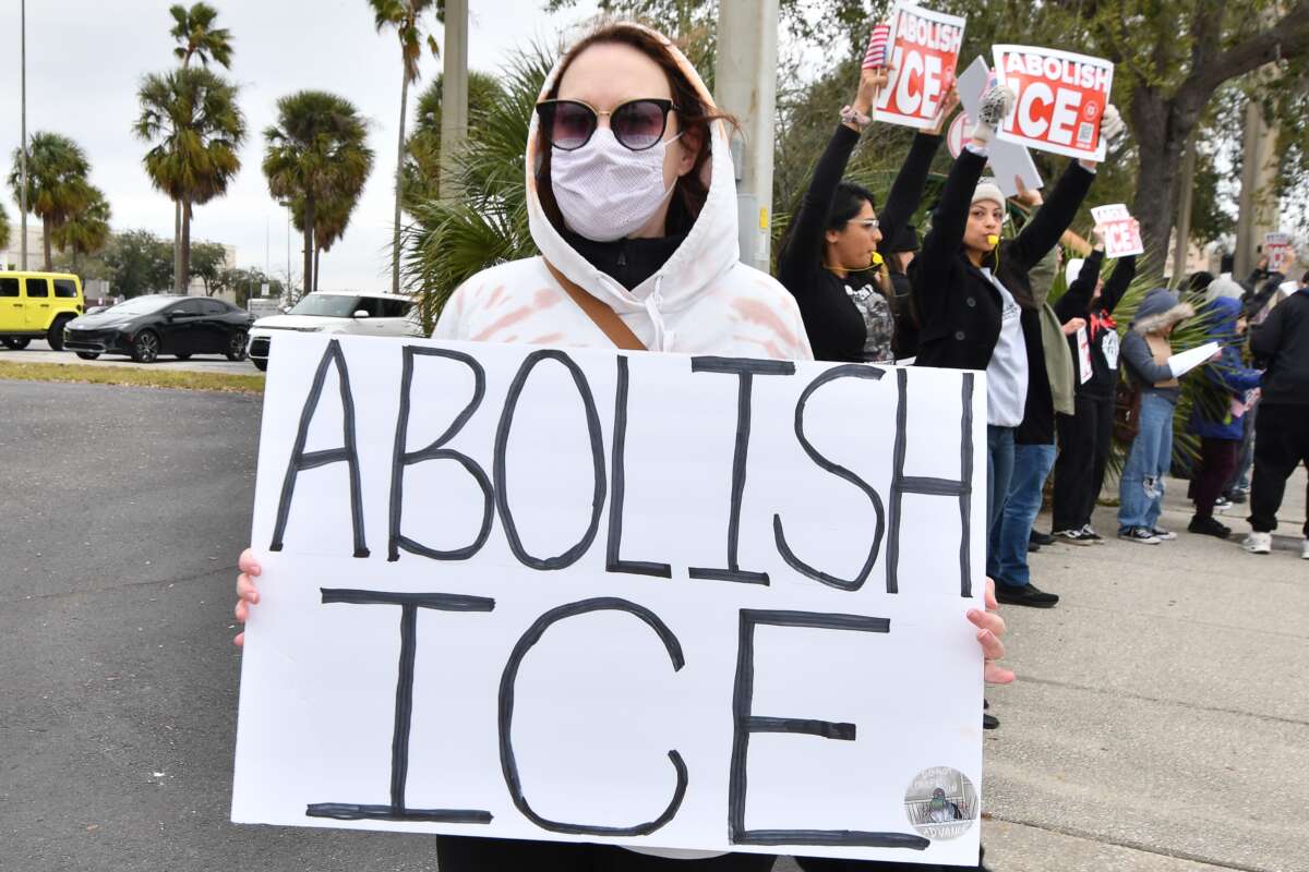 Protesters take to the streets in Orlando, Florida, on January 31, 2026, to demonstrate against the actions of ICE, chanting slogans and carrying signs.