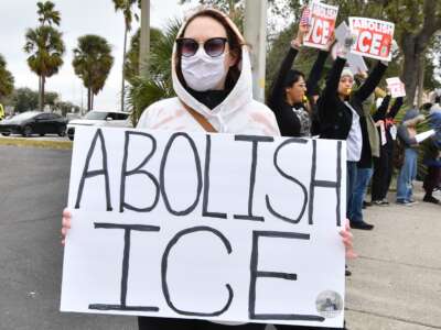 Protesters take to the streets in Orlando, Florida, on January 31, 2026, to demonstrate against the actions of ICE, chanting slogans and carrying signs.
