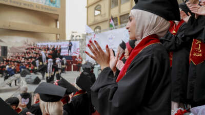 Graduates applaud during a graduation ceremony at Al-Azhar University in Gaza City, on February 9, 2026. University officials said the graduation reflects the continuation of academic programs despite repeated damage to infrastructure and limited resources, as graduates prepare to enter the healthcare sector in a territory facing severe medical shortages.