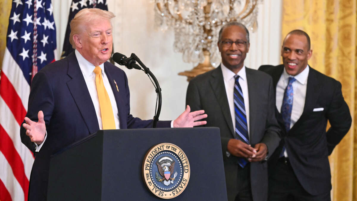 U.S. President Donald Trump speaks alongside former Secretary of Housing and Urban Development Ben Carson and current Secretary of Housing and Urban Development (HUD) Scott Turner during a Black History Month event in the East Room of the White House in Washington, D.C., on February 18, 2026.
