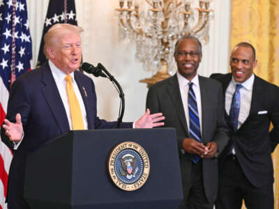 U.S. President Donald Trump speaks alongside former Secretary of Housing and Urban Development Ben Carson and current Secretary of Housing and Urban Development (HUD) Scott Turner during a Black History Month event in the East Room of the White House in Washington, D.C., on February 18, 2026.