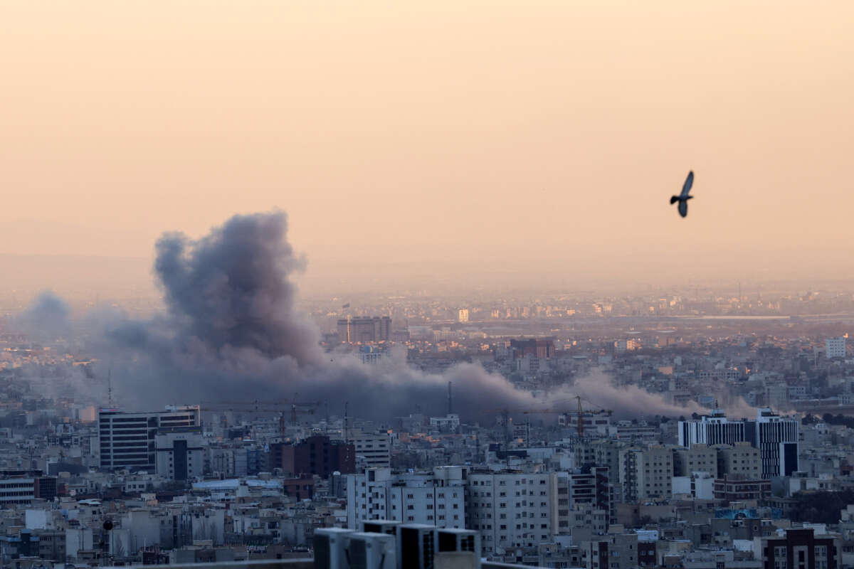 A plume of smoke rises after a strike on Tehran, Iran, on March 3, 2026.