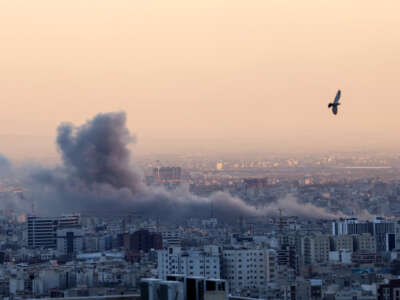 A plume of smoke rises after a strike on Tehran, Iran, on March 3, 2026.