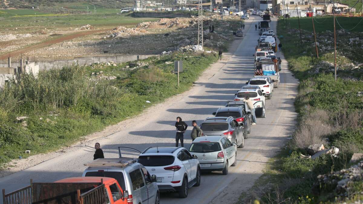 Palestinians wait at an Israeli military checkpoint in the northern West Bank near the city of Nablus, on March 3, 2026. Israeli forces closed all checkpoints at the entrances to areas under the control of the Palestinian Authority, headed by President Mahmoud Abbas, and arrested dozens of young Palestinians at the checkpoints after Israeli and US airstrikes on the Islamic Republic of Iran.