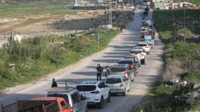 Palestinians wait at an Israeli military checkpoint in the northern West Bank near the city of Nablus, on March 3, 2026. Israeli forces closed all checkpoints at the entrances to areas under the control of the Palestinian Authority, headed by President Mahmoud Abbas, and arrested dozens of young Palestinians at the checkpoints after Israeli and US airstrikes on the Islamic Republic of Iran.