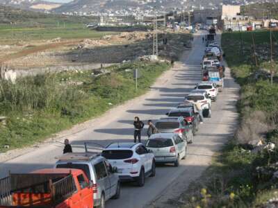 Palestinians wait at an Israeli military checkpoint in the northern West Bank near the city of Nablus, on March 3, 2026. Israeli forces closed all checkpoints at the entrances to areas under the control of the Palestinian Authority, headed by President Mahmoud Abbas, and arrested dozens of young Palestinians at the checkpoints after Israeli and US airstrikes on the Islamic Republic of Iran.