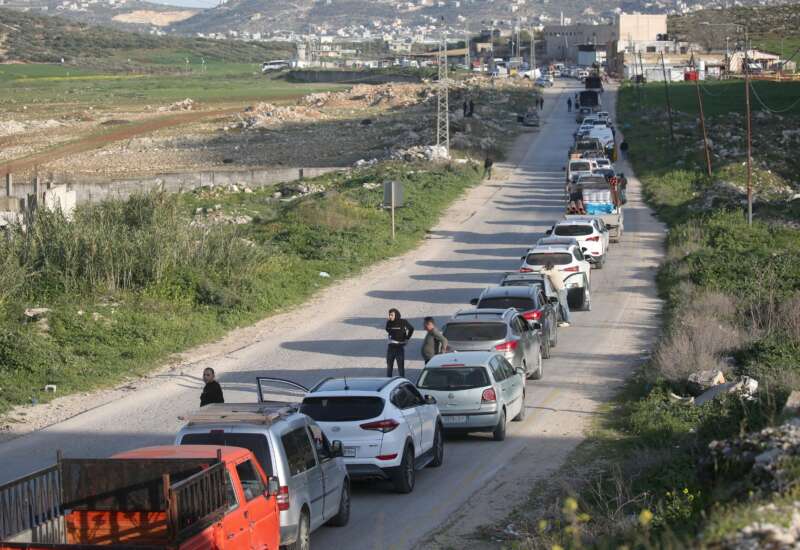 Palestinians wait at an Israeli military checkpoint in the northern West Bank near the city of Nablus, on March 3, 2026. Israeli forces closed all checkpoints at the entrances to areas under the control of the Palestinian Authority, headed by President Mahmoud Abbas, and arrested dozens of young Palestinians at the checkpoints after Israeli and US airstrikes on the Islamic Republic of Iran.