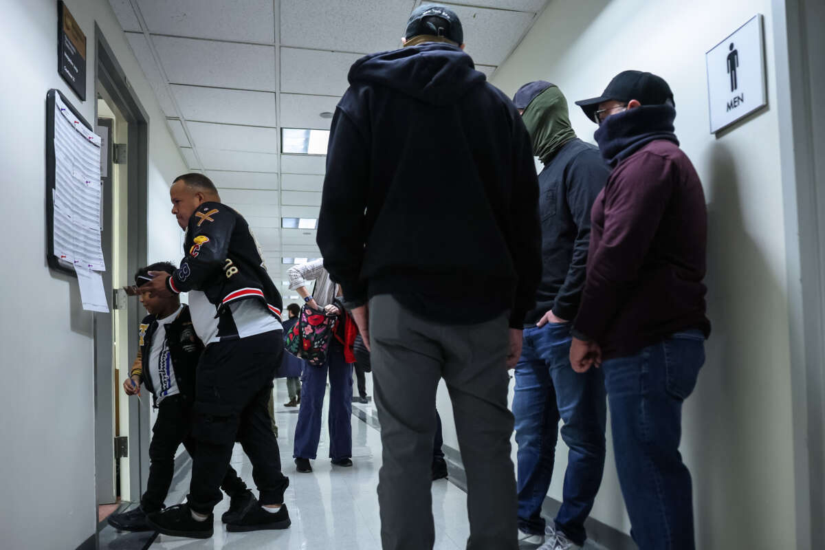 A man from Venezuela walks in to his court hearing with his son as federal agents patrol the halls of immigration court at the Jacob K. Javits Federal Building on March 5, 2026 in New York City.