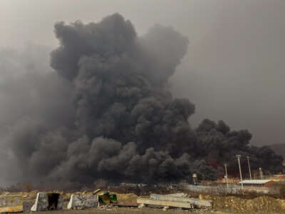 Smoke and flames rise at the site of airstrikes on an oil depot in Tehran, Iran, on March 8, 2026.