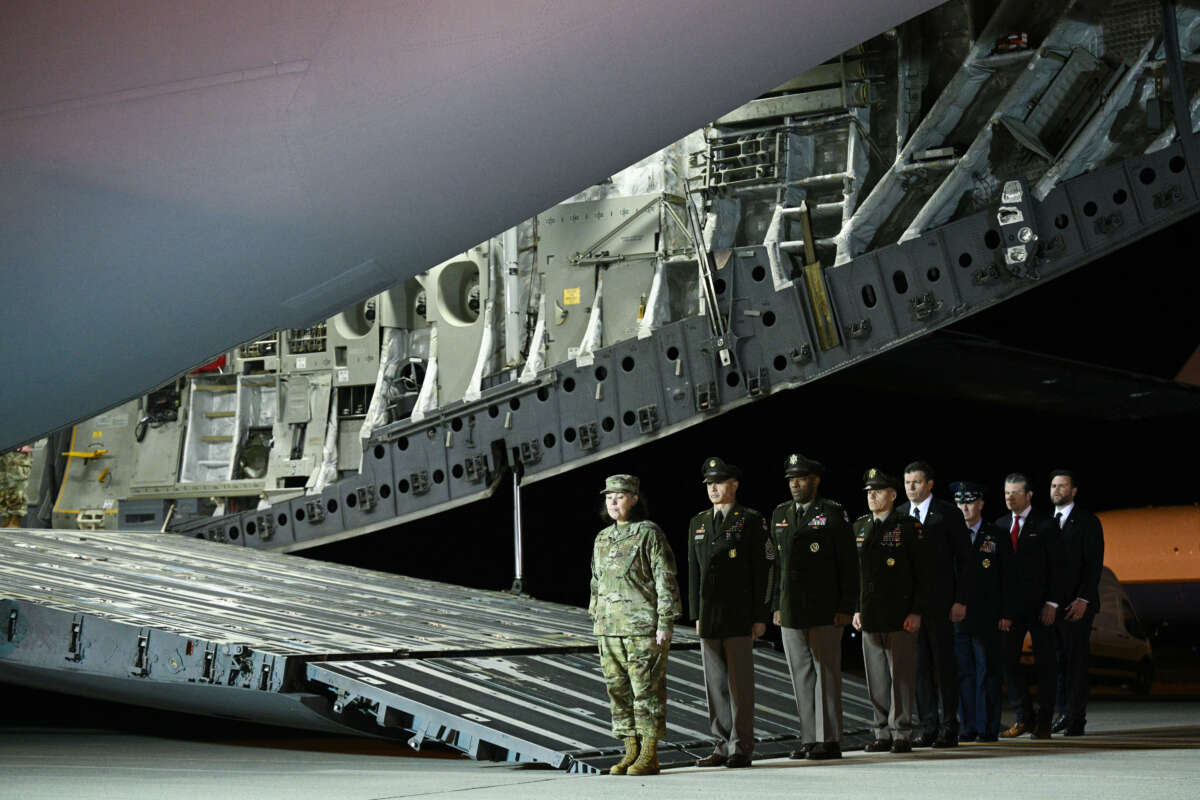 US military leaders line up in front of a military plane