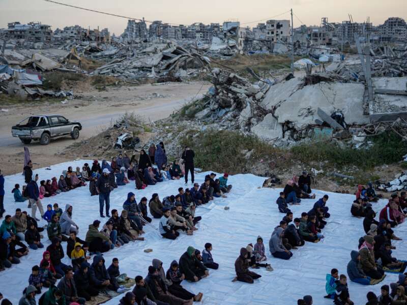 People attend morning prayers during Eid al-Fitr on March 20, 2026, in the Tel al-Hawa area of Gaza City, Gaza.