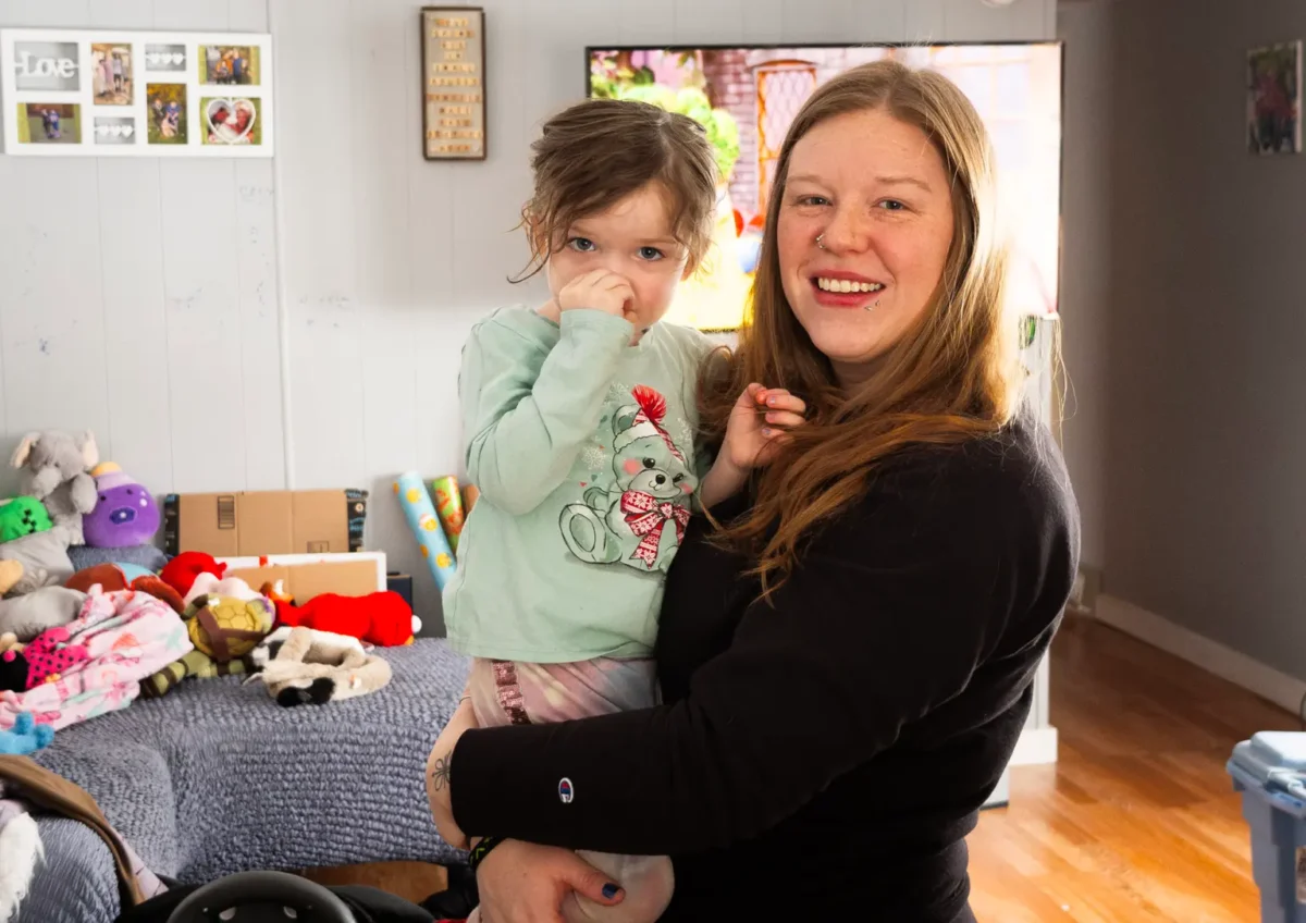 Candace May holds her daughter, Nova, in their home at Valley View Estates. May and other residents are making plans for where they will live after their eviction in April.