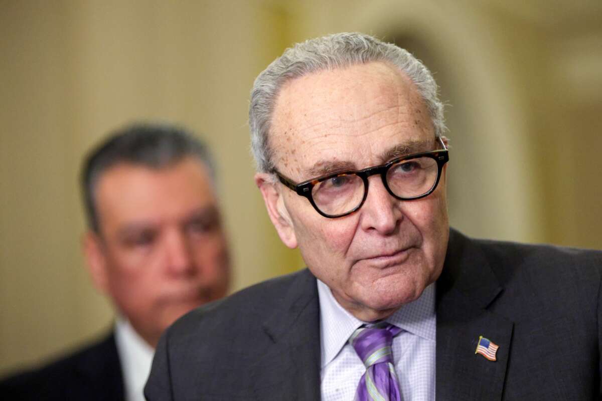 (R-L) U.S. Senate Minority Leader Sen. Chuck Schumer (D-NY) speaks as Sen. Alex Padilla (D-CA) listens during a news briefing on March 24, 2026 in Washington, D.C.