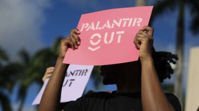 Protesters make themselves heard near Palantir’s new headquarters on March 03, 2026 in Aventura, Florida. Before relocating to Aventura in February 2026, Palantir had its headquarters in Denver, Colorado.