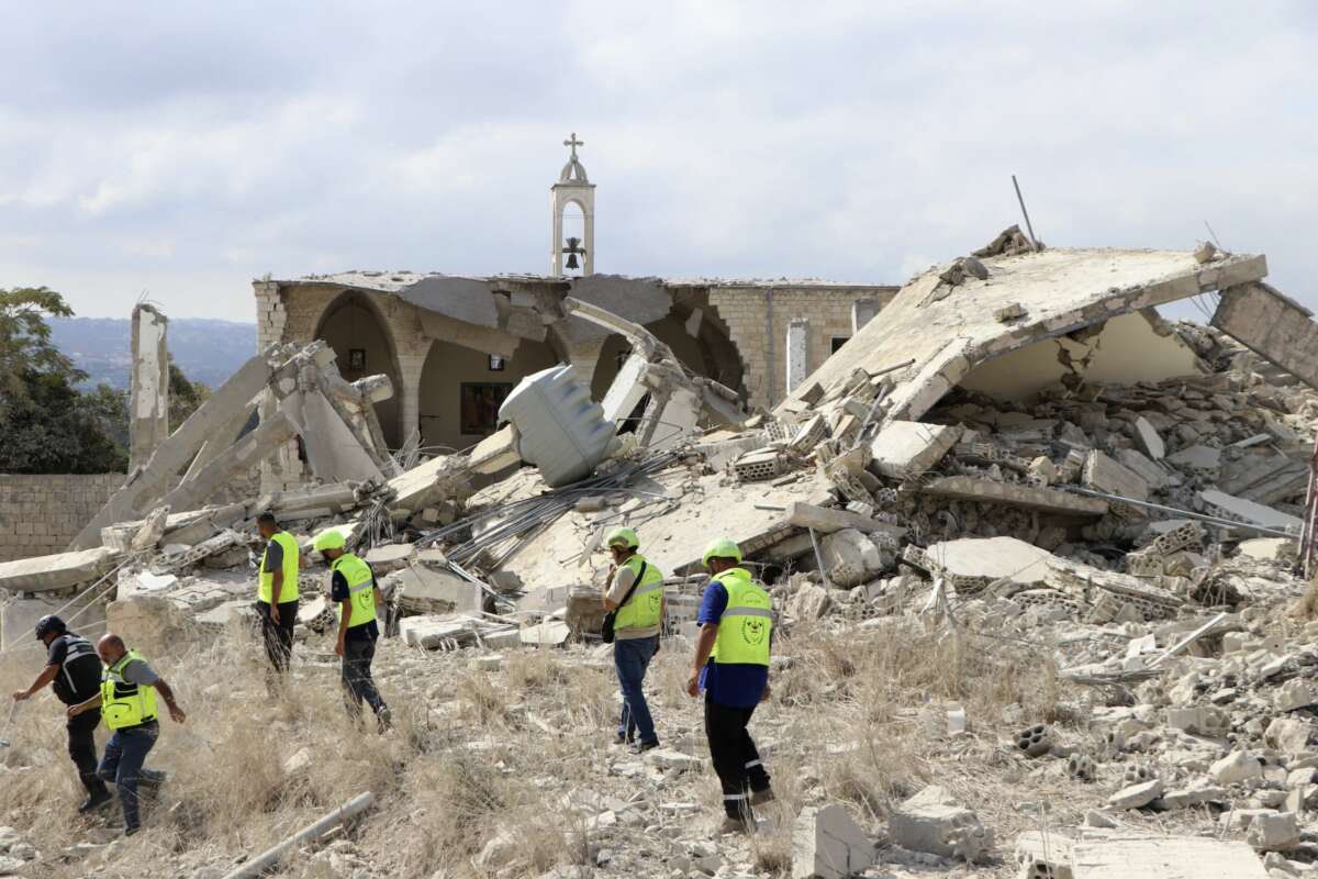 Rescuers walk near a destroyed church as they check the site of an overnight Israeli airstrike that targeted the southern Lebanese village of Derdghaiya on October 10, 2024, amid the war between Israel and Hezbollah.