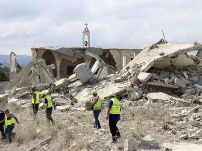 Rescuers walk near a destroyed church as they check the site of an overnight Israeli airstrike that targeted the southern Lebanese village of Derdghaiya on October 10, 2024, amid the war between Israel and Hezbollah.