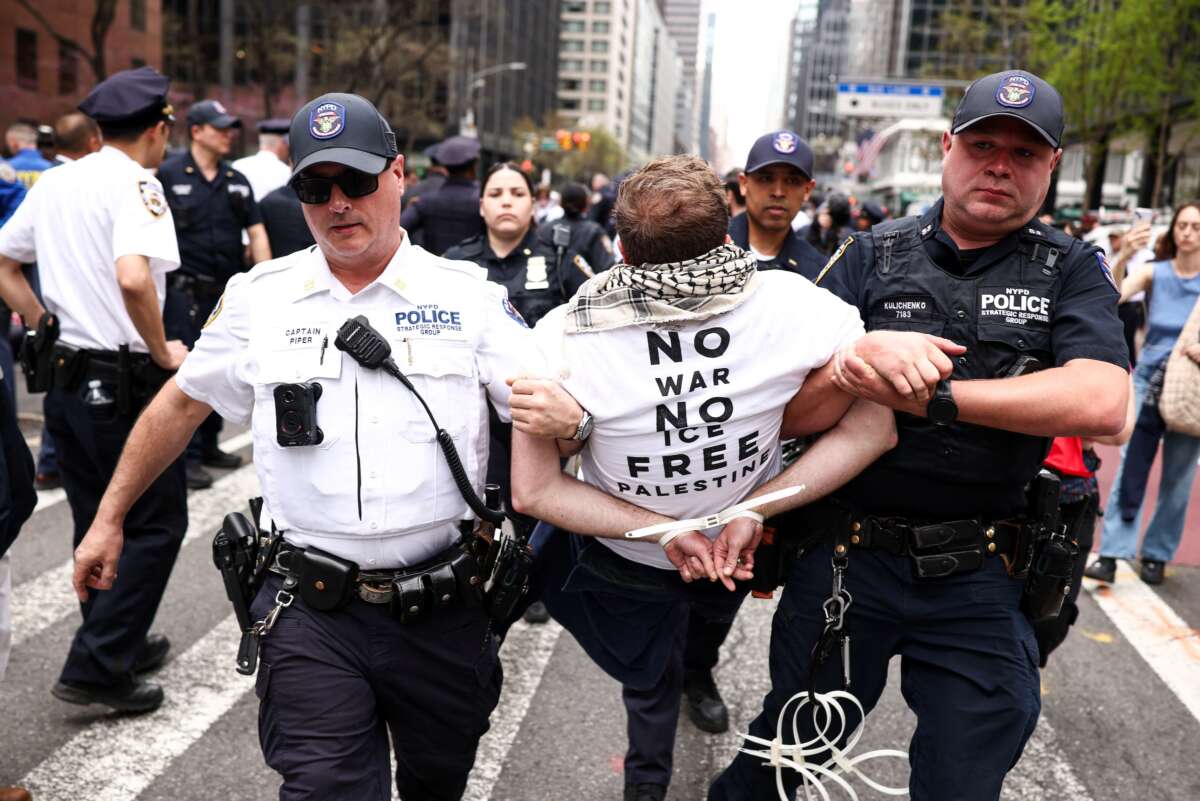 A protester is arrested by police during a demonstration and sit-in on Third Avenue in New York City on April 13, 2026. People gathered in front of the office of U.S. Senate Minority Leader Chuck Schumer's office to protest against the war in Iran, Immigration and Customs Enforcement (ICE) and in support of Palestinians.