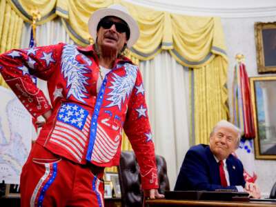 U.S. President Donald Trump listens as entertainer Kid Rock speaks during an executive order signing event in the Oval Office of the White House on March 31, 2025 in Washington, D.C.