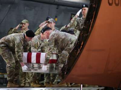 A U.S. Army carry team moves a flag-draped transfer case containing the remains of Maj. Sorffly Davius, 46, of Cambria Heights, Queens, N.Y. at Dover Air Force Base on March 9, 2026 in Dover, Delaware.