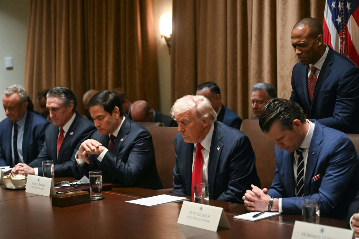 U.S. President Donald Trump bows his head in prayer during a cabinet meeting at the White House in Washington, D.C., on February 26, 2025. Also pictured, L-R, Secretary of Health and Human Services nominee Robert F. Kennedy Jr., Secretary of the Interior Doug Burgum, Secretary of State Marco Rubio, Secretary of Defense Pete Hegseth, and Housing and Urban Development Secretary Scott Turner.