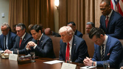 U.S. President Donald Trump bows his head in prayer during a cabinet meeting at the White House in Washington, D.C., on February 26, 2025. Also pictured, L-R, Secretary of Health and Human Services nominee Robert F. Kennedy Jr., Secretary of the Interior Doug Burgum, Secretary of State Marco Rubio, Secretary of Defense Pete Hegseth, and Housing and Urban Development Secretary Scott Turner.