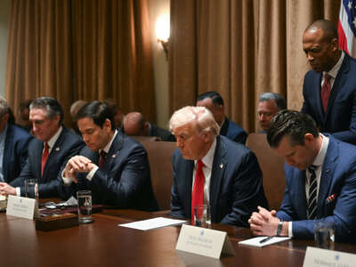 U.S. President Donald Trump bows his head in prayer during a cabinet meeting at the White House in Washington, D.C., on February 26, 2025. Also pictured, L-R, Secretary of Health and Human Services nominee Robert F. Kennedy Jr., Secretary of the Interior Doug Burgum, Secretary of State Marco Rubio, Secretary of Defense Pete Hegseth, and Housing and Urban Development Secretary Scott Turner.