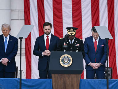 President Donald Trump, Vice President JD Vance, and Secretary of Defense Pete Hegseth bow their heads during the invocation the amphitheatre at the Tomb of the Unknown Soldier in Arlington National Cemetery in Arlington, Virginia, on Memorial Day, May 26, 2025.