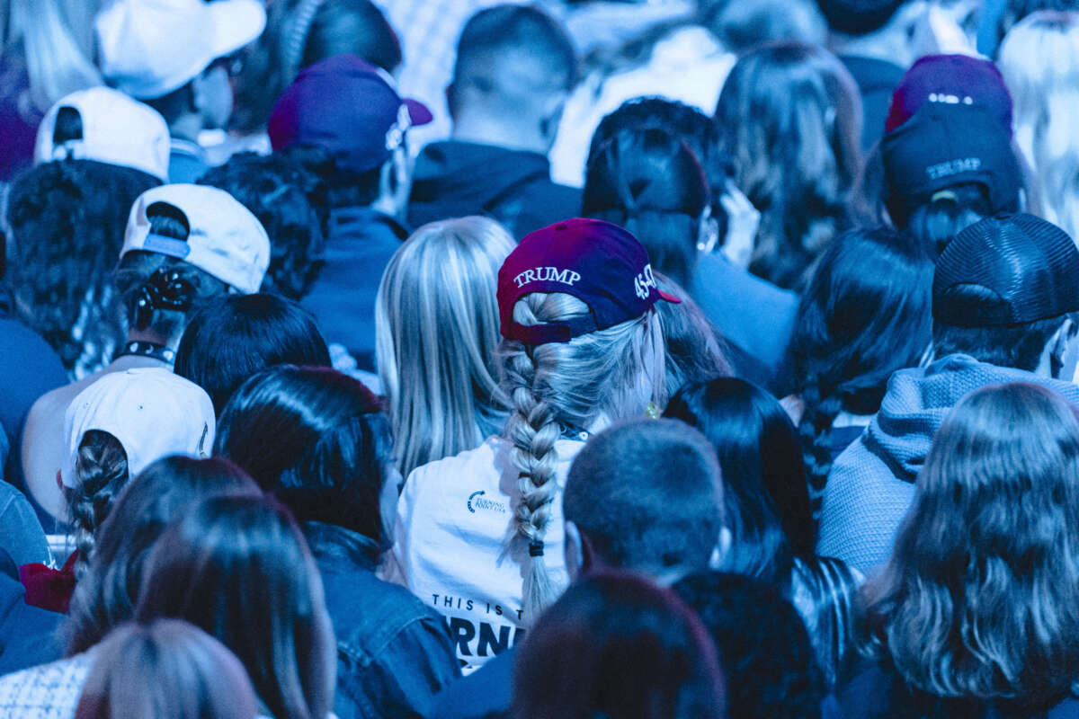 Attendees wear Trump hats during Turning Point's annual AmericaFest conference in Phoenix, Arizona, on December 21, 2025.
