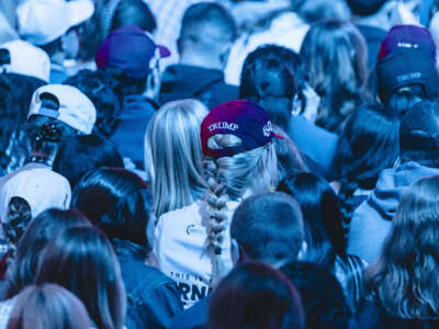 Attendees wear Trump hats during Turning Point's annual AmericaFest conference in Phoenix, Arizona, on December 21, 2025.