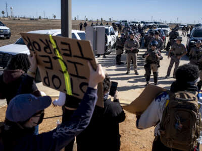 Texas State Troopers prepare to disperse a crowd protesting Immigration and Customs Enforcement outside the South Texas Family Residential Center on January 28, 2026 in Dilley, Texas.