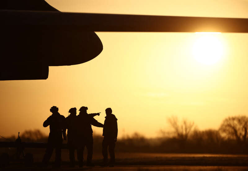 USAF military personnel work beneath a US Air Force (USAF) B-1 Lancer bomber jet at RAF Fairford in south-west England on March 14, 2026.
