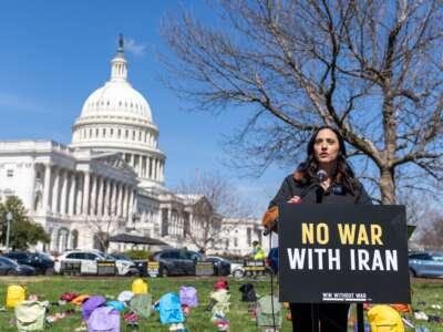 Rep. Yassamin Ansari (D-AZ) speaks on Capitol Grounds in front of a memorial of 168 pairs of shoes representing those killed in the U.S. strike that killed over 150 schoolchildren, on March 18, 2026, in Washington, D.C.