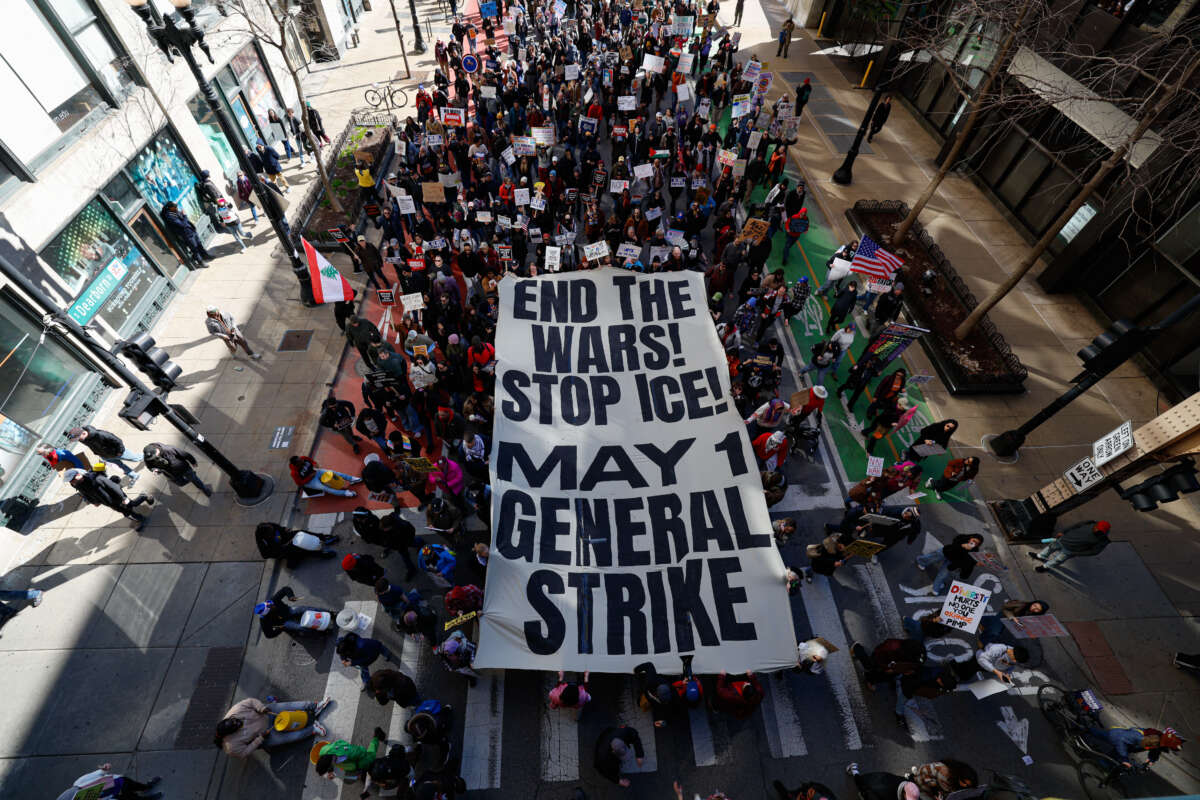 People hold a banner reading "End the Wars, Stop ICE, May 1 General Strike" as they march during the "No Kings" national day of protest in Chicago on March 28, 2026.