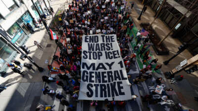 People hold a banner reading "End the Wars, Stop ICE, May 1 General Strike" as they march during the "No Kings" national day of protest in Chicago on March 28, 2026.