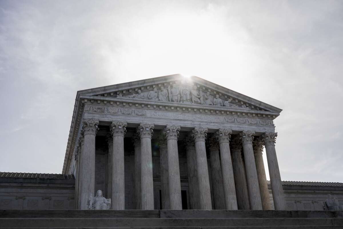 The sun rises above a facade of the U.S. Supreme Court building on March 31, 2026, in Washington, D.C.