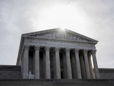 The sun rises above a facade of the U.S. Supreme Court building on March 31, 2026, in Washington, D.C.