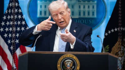 President Donald Trump mimics firing a gun during a news conference in the White House briefing room about the war in Iran on April 6, 2026.