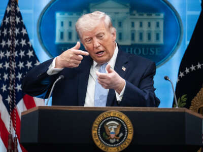 President Donald Trump mimics firing a gun during a news conference in the White House briefing room about the war in Iran on April 6, 2026.