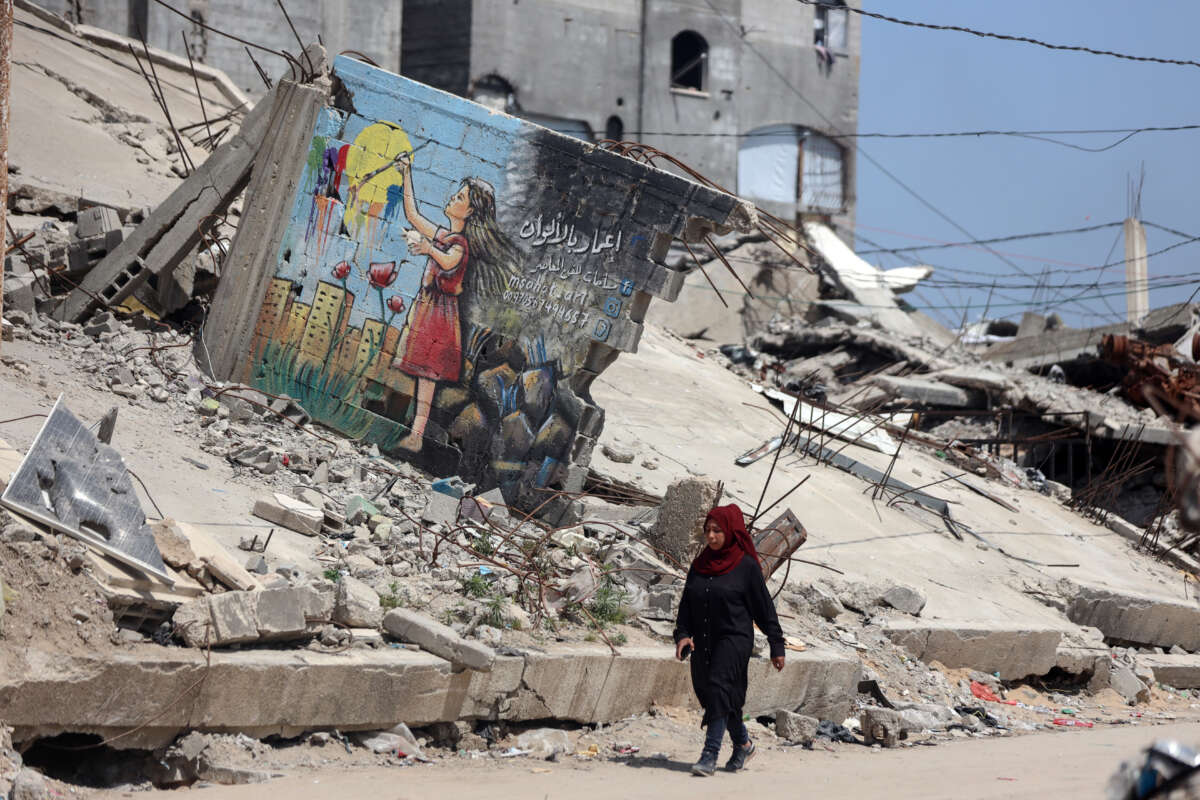 People walk past the rubble of destroyed buildings in the Jabalia camp for Palestinian refugees in the northern Gaza Strip, on April 13, 2026.