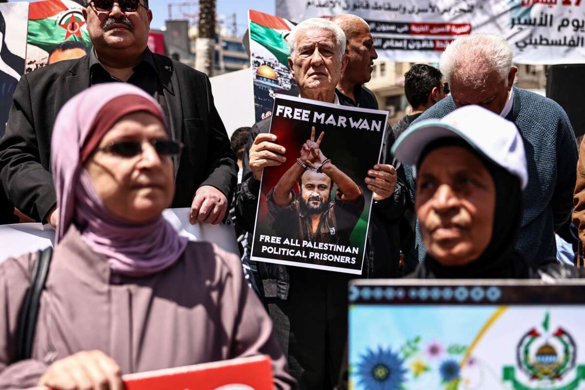 Palestinian demonstrators hold pictures of prisoners held in Israeli jails, including jailed Palestinian leader Marwan Barghouti, during a rally in Ramallah, in the occupied West Bank, on April 16, 2026, to mark Prisoners' Day and to protest against Israeli parliament's approval of a new death penalty bill for Palestinians.
