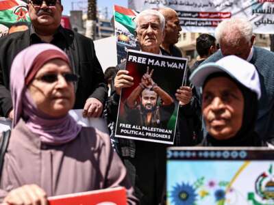 Palestinian demonstrators hold pictures of prisoners held in Israeli jails, including jailed Palestinian leader Marwan Barghouti, during a rally in Ramallah, in the occupied West Bank, on April 16, 2026, to mark Prisoners' Day and to protest against Israeli parliament's approval of a new death penalty bill for Palestinians.
