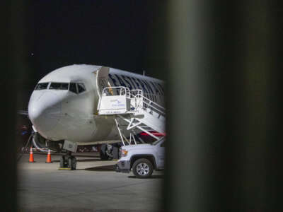 An airplane sits on the tarmac at Mesa Gateway Airport on the evening of April 9, 2026, outside of the Arizona Removal Operations Coordination Center, an ICE facility where detainees are temporarily housed before they are put on a plane to either be deported or moved to a different ICE facility.