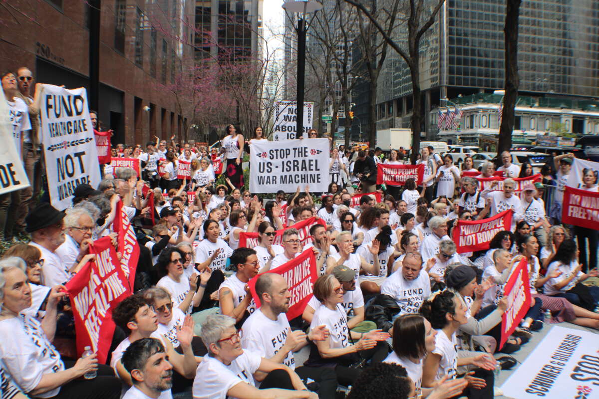 Protesters with a coalition of 18 movement organizations block the entrance to Senators Chuck Schumer’s and Kirsten Gillibrand’s offices, chanting: “Fund people, not bombs,” on April 13, 2026.