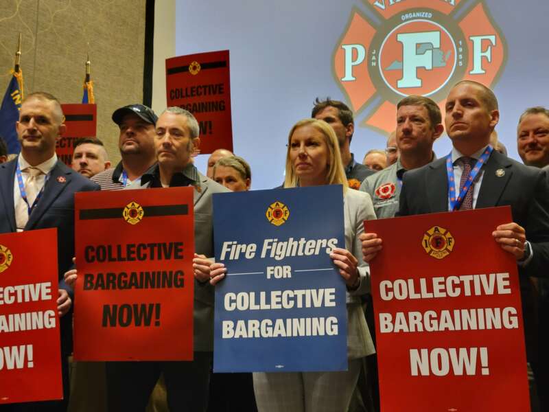 Members of Virginia Professional Firefighters association hold signs during their biannual convention to protest Gov. Abigail Spanberger’s veto of collective bargaining legislation.