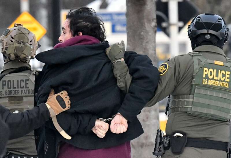 Federal agents detain a man as protestors demonstrate in Saint Paul, Minnesota, on January 8, 2026.