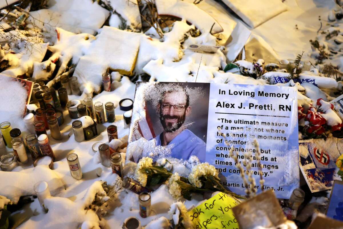 A sign with a picture of Alex Pretti is seen in the snow covered makeshift memorial, set up in the area where he was shot and killed by federal immigration agents, in Minneapolis, Minnesota, on February 1, 2026.