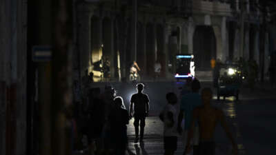 People walk on a street during a blackout in Havana on May 13, 2026.